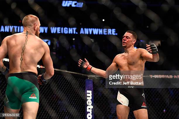 Nate Diaz gestures towards Conor McGregor of Ireland in their welterweight bout during the UFC 202 event at T-Mobile Arena on August 20, 2016 in Las...