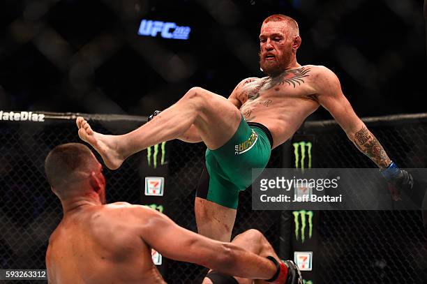 Conor McGregor of Ireland knocks down Nate Diaz in their welterweight bout during the UFC 202 event at T-Mobile Arena on August 20, 2016 in Las...
