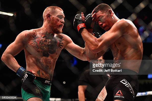 Conor McGregor of Ireland punches Nate Diaz in their welterweight bout during the UFC 202 event at T-Mobile Arena on August 20, 2016 in Las Vegas,...
