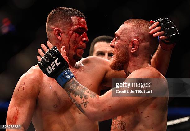 Nate Diaz and Conor McGregor of Ireland embrace after finishing five rounds in their welterweight bout during the UFC 202 event at T-Mobile Arena on...