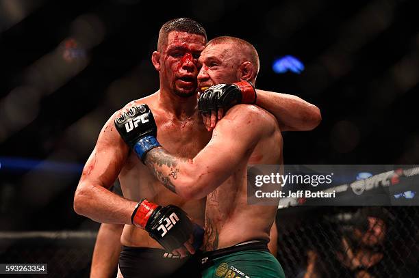 Nate Diaz and Conor McGregor of Ireland embrace after finishing five rounds in their welterweight bout during the UFC 202 event at T-Mobile Arena on...