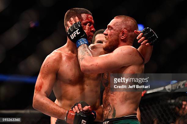 Nate Diaz and Conor McGregor of Ireland embrace after finishing five rounds in their welterweight bout during the UFC 202 event at T-Mobile Arena on...