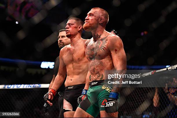 Nate Diaz and Conor McGregor of Ireland embrace after finishing five rounds in their welterweight bout during the UFC 202 event at T-Mobile Arena on...