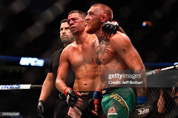 Nate Diaz and Conor McGregor of Ireland embrace after finishing five rounds in their welterweight bout during the UFC 202 event at T-Mobile Arena on...