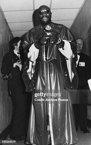 Actor and singer Isaac Hayes wearing a long robe and holding his award, at the Grammy Awards, Felt Forum, New York, March 14th 1972.