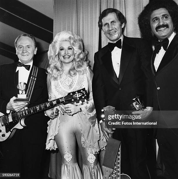 Portrait of, from left, American musicians Les Paul , Dolly Parton, Chet Atkins , and Freddie Fender , as they pose together during the 19th annual...