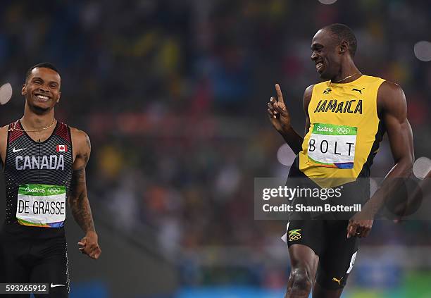 Usain Bolt of Jamaica celebrates with Andre de Grasse of Canadaza after crossing the finish line during the Men's 200m semifinal on Day 12 of the Rio...