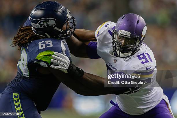 Defensive end Zach Moore of the Minnesota Vikings battles offensive tackle Terry Poole of the Seattle Seahawks at CenturyLink Field on August 18,...