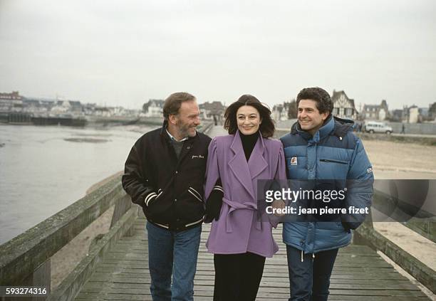 French actors Jean-Louis Trintignant and Anouk Aimee with director, screenwriter and producer Claude Lelouch on the set of his movie Un Homme et une...