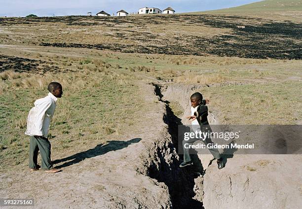 Positive orphan Zamokuhle Mdingwe leaps a donga as he takes a shortcut on the way to school. It is more than a year since Zamo began his...