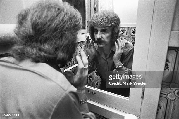 Rock & Roll songwriter and record producer, Phil Spector styles his hair in the bathroom of his Beverly Hills estate. On February 3 Phil Spector, age...