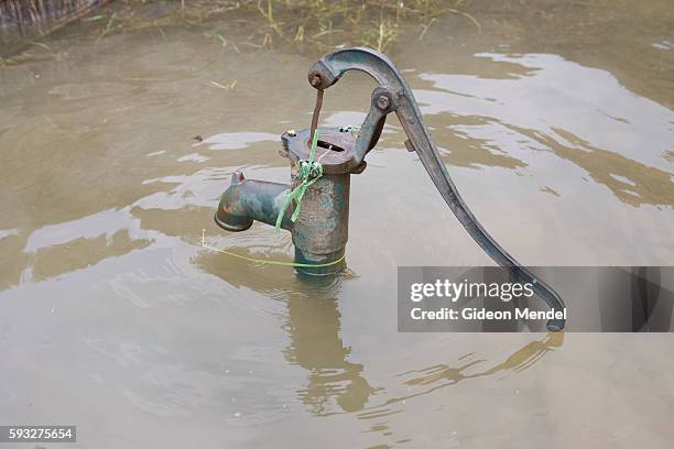 Hand pump in the flooded village of Chajan Mania near Muzaffarpur. The floodwaters were slowly receding and the pump had just emerged from the water...