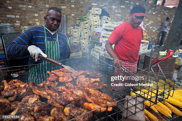 Caribbean style jerk chicken and corn is barbecued at one of the many food stalls at the Notting Hill Carnival.