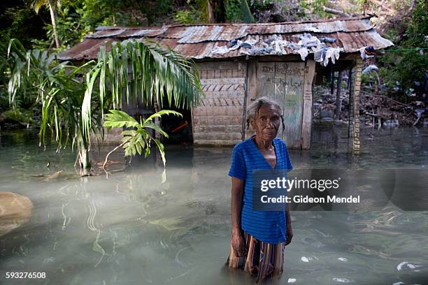 Marie Miracle Andris aged 75 stands in front of her flooded house in Marigot in southeast Haiti. Her house was flooded and damaged by Hurricane...