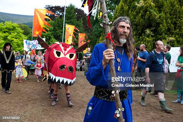 Druid leads the children's procession during the Green Man festival. This is an independent music festival held annually in a stunning natural...