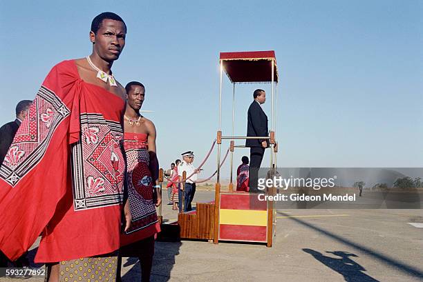 Pomp and ceremony at Matsapa airport as His Majesty King Mswati III arrives back in Swaziland from a state visit to Kenya. The King stands on a...