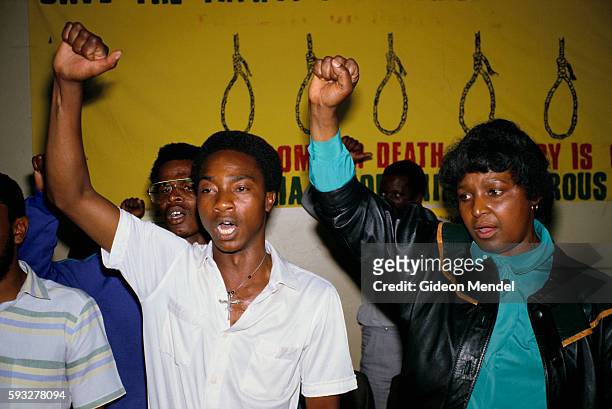 Winnie Mandela salutes an ANC fighter after his execution by the government. She was attending a memorial service for him, in Johannesburg, South...