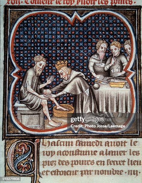 The piety of king Louis IX : he feeds the poor and washes the poor men's feet. Miniature from the manuscript "Les Grandes Chroniques de France" by...