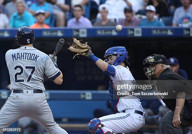 Josh Thole of the Toronto Blue Jays is charged with a passed ball on a knuckleball thrown by R.A. Dickey in the first inning during MLB game action...