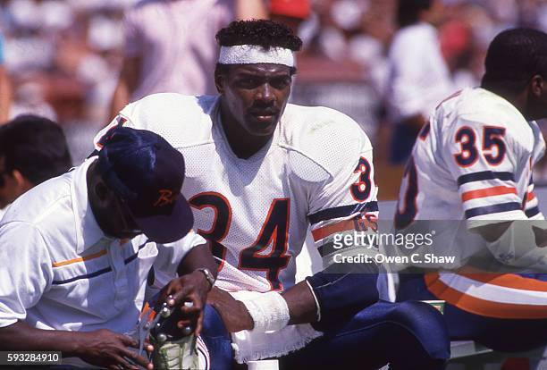 Walter Payton of the Chicago Bears circa 1987 sits on sideline against the Los Angeles Raiders at the Coliseum in Los Angeles, California.