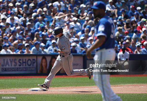 Alex Dickerson of the San Diego Padres circles the bases after hitting a solo home run in the eighth inning during MLB game action as Franklin...