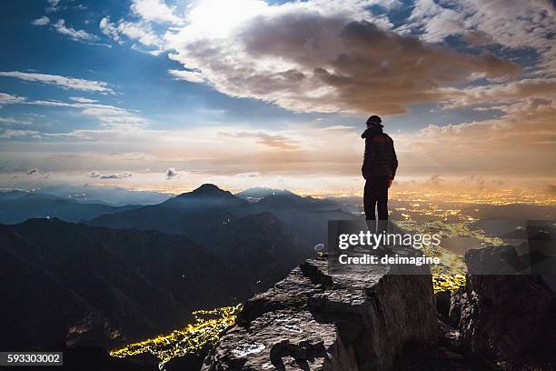 hiker top of the mount at night - mountain peak view stock pictures, royalty-free photos & images