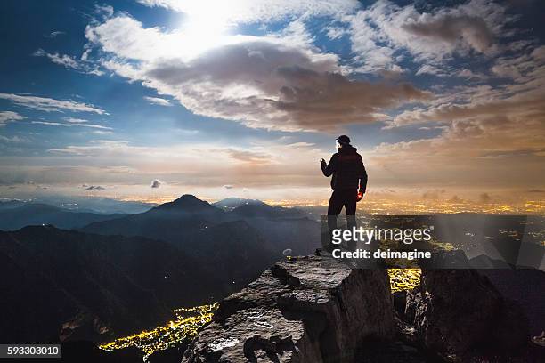 hiker checks your device on top on the mount - checking sports stock pictures, royalty-free photos & images