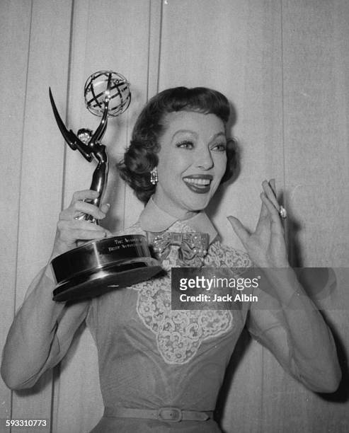 Actress Loretta Young holding her Best Actress award at the Emmy Awards, 1955.