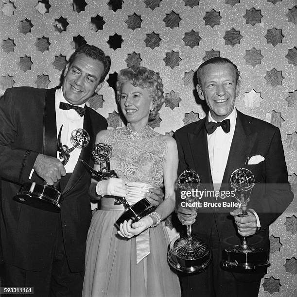Award winners Raymond Burr, Barbara Stanwyck and Fred Astaire holding their statuettes at the Emmy Awards, May 1961.