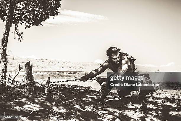 model wearing lion makeup & costume  leaping from a tree - broken tree stock pictures, royalty-free photos & images