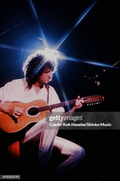 Queen Brian May live at Tokorozawa Seibu Lion's Baseball Stadium plays 12 string acoustic guitar, Saitama, November 3, 1982.