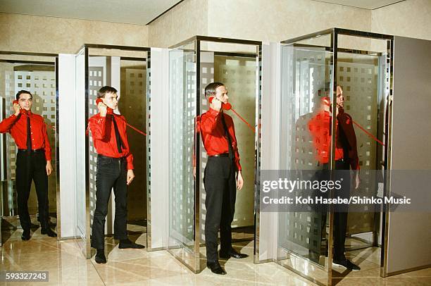 Kraftwerk standing in phone booth in Keio Plaza Hotel, Tokyo, September 1981.