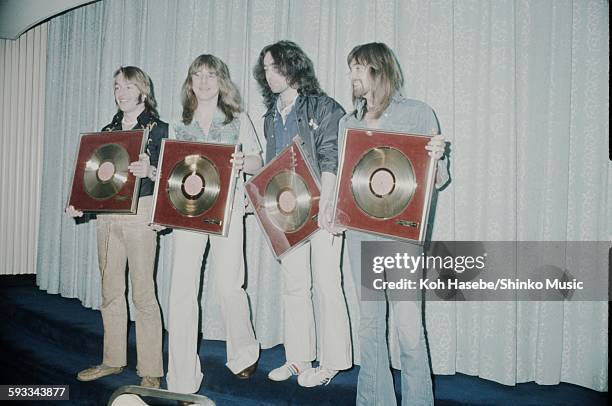 Bad Company holding gold disc, Tokyo, March 1975.