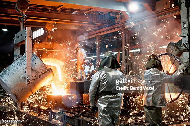 steel workers working with liquid metal - blast furnace stock pictures, royalty-free photos & images