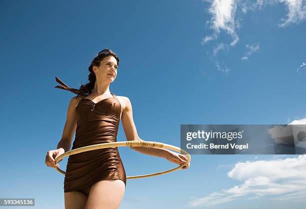 woman holding toy hoop - one piece swimsuit stock pictures, royalty-free photos & images