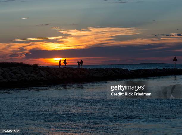 Sunset over Menemsha Sound in the town of Chilmark on Martha's Vineyard, MA over looking beach in the town of Aquinnah, formerly known at Gay Head on...