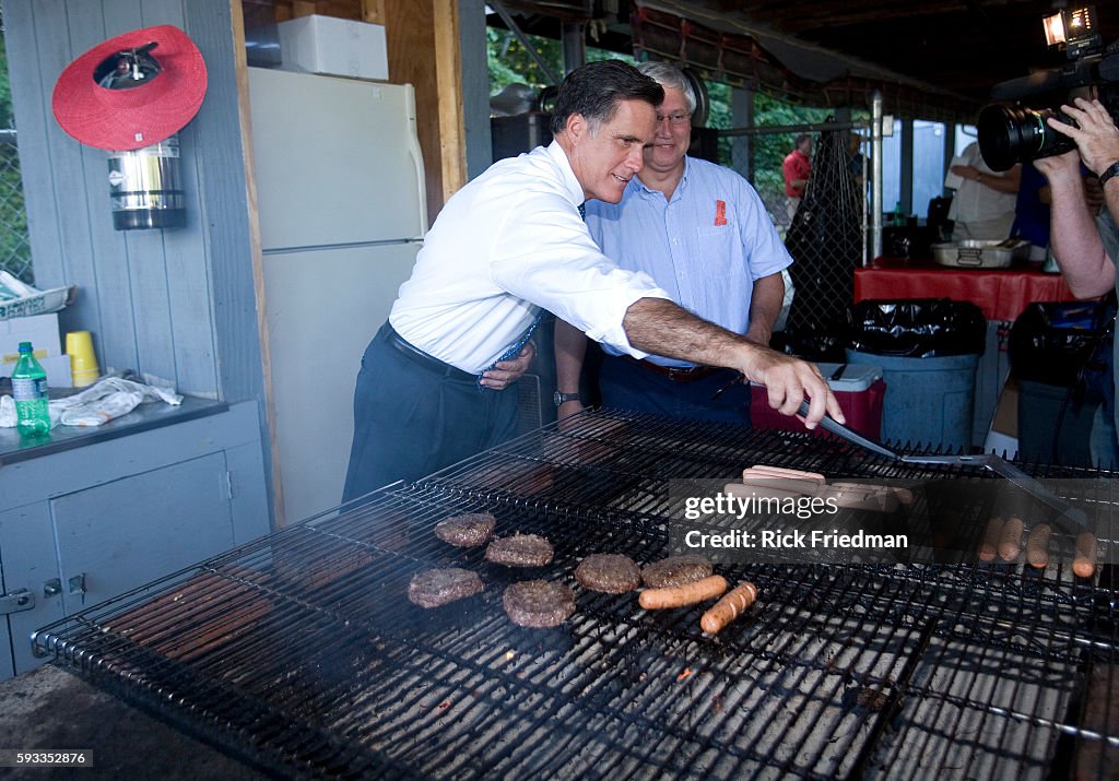 Mitt Romney flips hamburgers and hot dogs