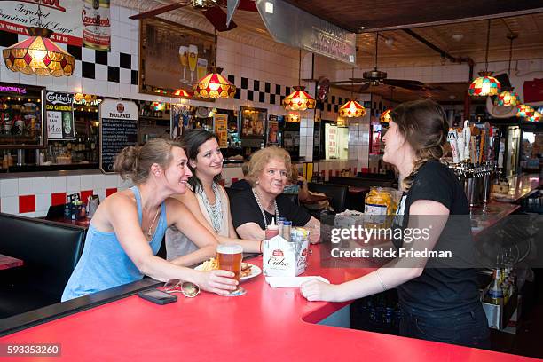 Helen Metros, an 83 year old waitress at Charlie's Kitchen in Harvard Sq, Cambridge, MA on August 21, 2013 with Alix Easton of Brighton and Nina...