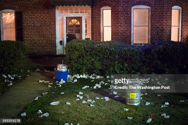 Cups and trash are seen in front of houses after people marched up and down Wertland Street going to house parties during the unofficial party known...