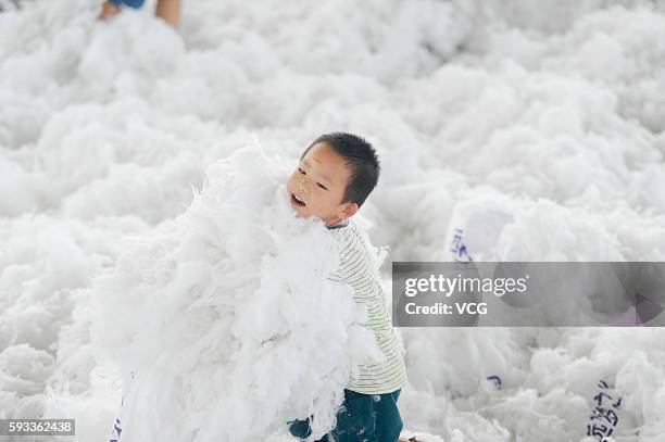 Boy fights with pillows in the stress-relief festival held at Guanyin Mountain on August 21, 2016 in Dongguan, Guangdong Province of China. White...