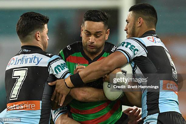 John Sutton of the Rabbitohs is tackled during the round 24 NRL match between the South Sydney Rabbitohs and the Cronulla Sharks at ANZ Stadium on...