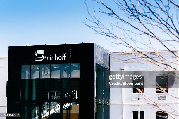 Steinhoff International Holdings NV logo sits on display outside the company's offices in Stellenbosch, South Africa, on Wednesday, Aug. 17, 2016....