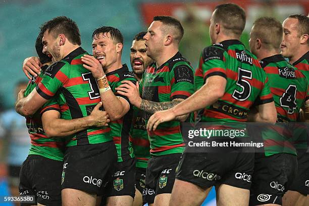 Cody Walker of the Rabbitohs celebrates scoring a try with team mates during the round 24 NRL match between the South Sydney Rabbitohs and the...