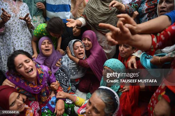 Relatives of Kashmiri teenager Irfan Ahmed, who was killed by a teargas shell, break down as local residents visit the family to offer their...