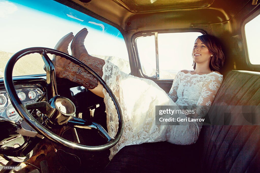 Bride sitting in a vintage car