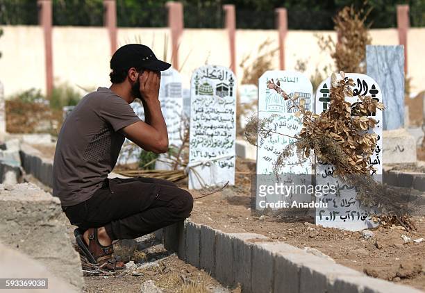 Man prays at his relative's tomb during 3rd anniversary of Assad regime forces' chemical attack to East Ghouta of Damascus in Syria on August 21,...