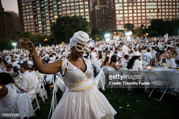 People attend Diner en Blanc , a pop-up dinner held once a year in New York on August 25, 2014 in the Battery Park City neighborhood of New York...