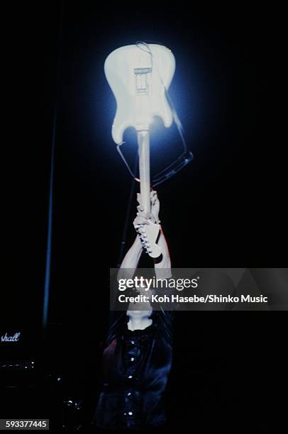 Rainbow Ritchie Blackmore holding guitar high at Nippon Budokan, Tokyo, May 8, 1980.