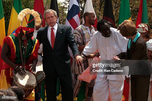 President George Bush and First Lady Laura Bush dance with the Kankouran West African Dance Company on Malaria Awareness Day, in Rose Garden of the...