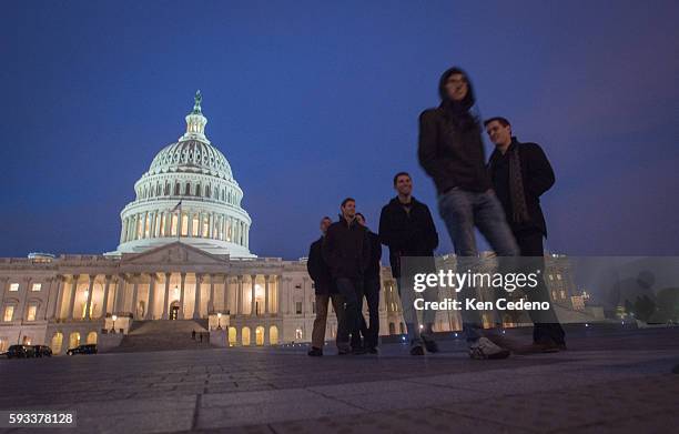 Visitors at the U.S Capitol January 1, 2013 as U.S. Lawmakers work hard toward a midnight deadline averting hundreds of billions of dollars in tax...